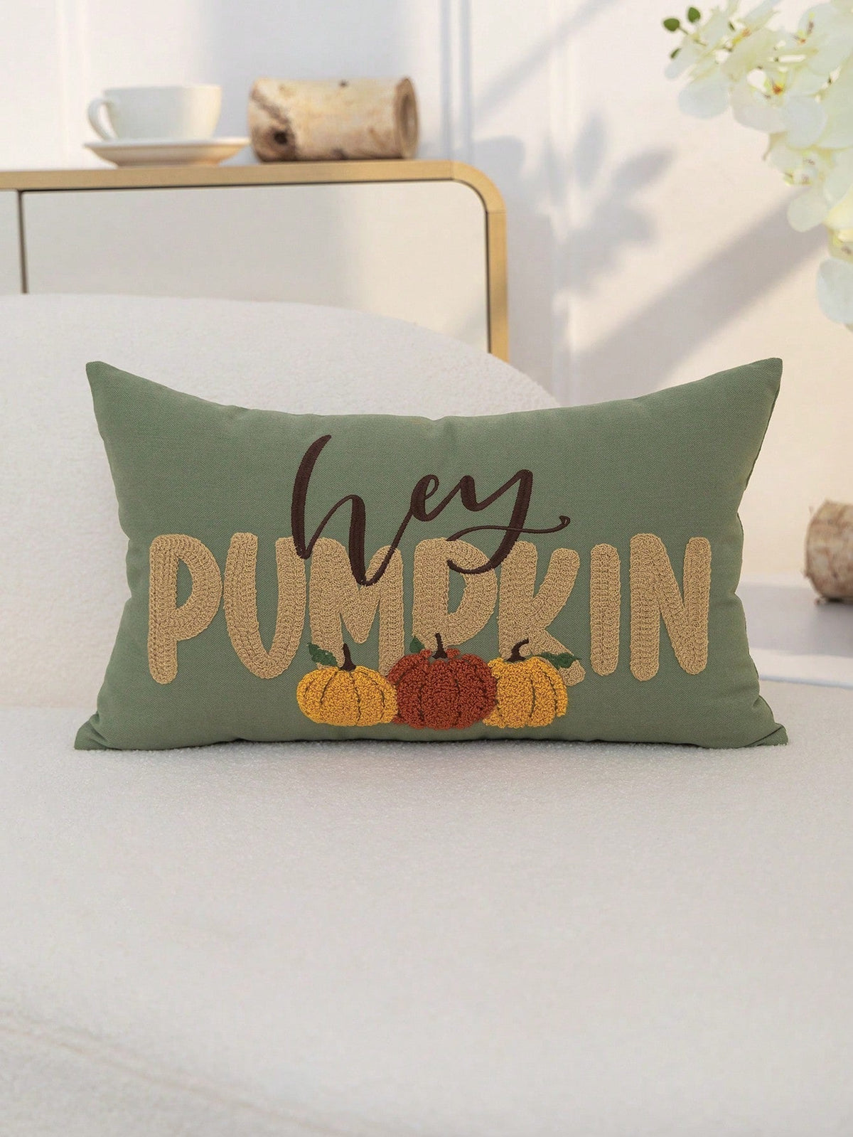 Hey Pumpkin embroidered lumbar cushion cover in sage green on white bed with neutral bedroom styling
