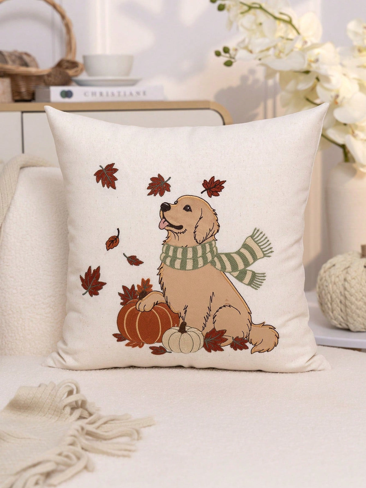 Golden retriever autumn embroidered cushion cover on cream sofa with pumpkins and swirling maple leaf detail