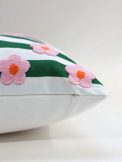 Decorative pillow with green stripes and pink flowers on a white background