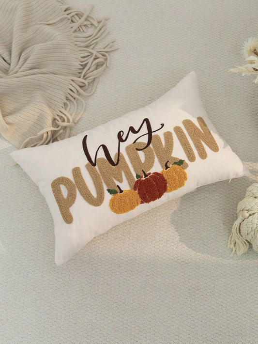 Hey Pumpkin embroidered lumbar cushion cover in white on grey textured surface with cream tassel throw and white florals