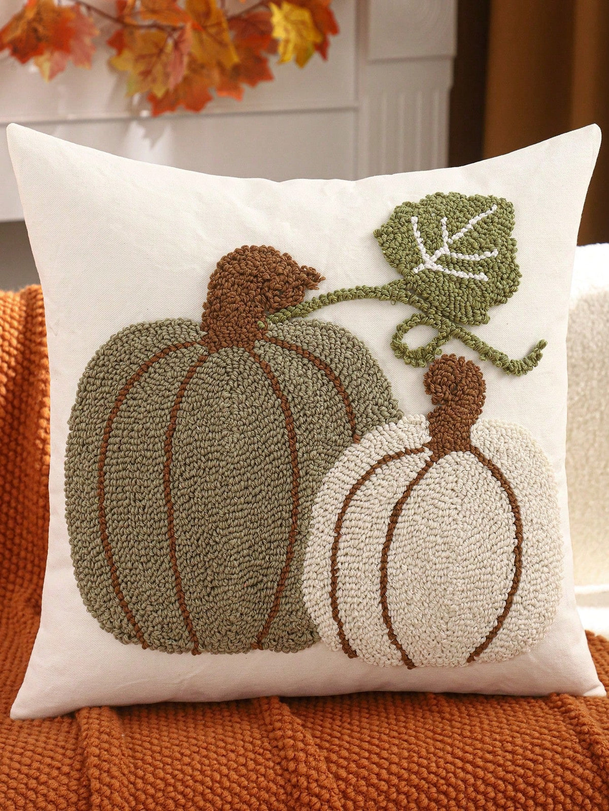 Tufted pumpkin duo cushion cover - sage & cream on white, styled on burnt orange knit sofa with autumn leaf decor