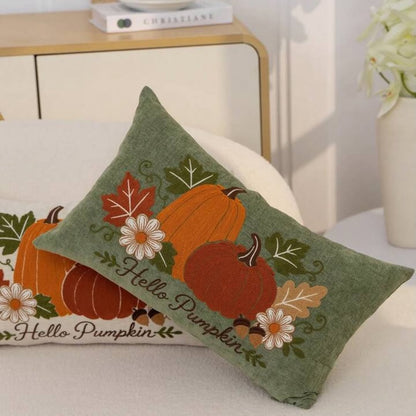 Hello Pumpkin embroidered cushion covers in sage green - square and lumbar sizes on white surface with dresser background
