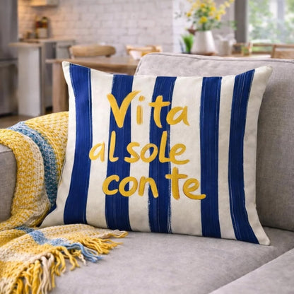 Blue and white Mediterranean striped pillow cover with Vita al Sole Con Te typography on modern sofa