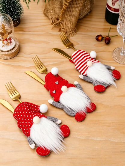Christmas gnome silverware holders on table with gold cutlery