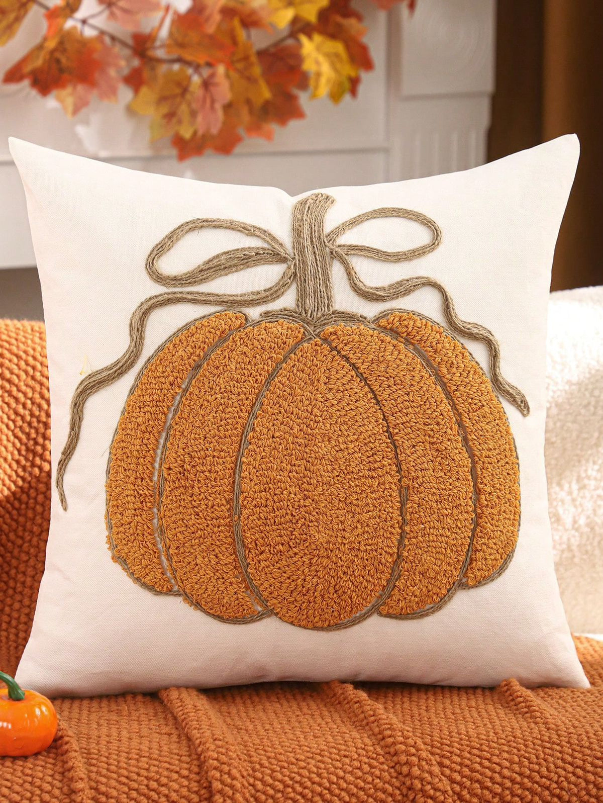 Chenille pumpkin pillow cover in pumpkin orange with jute bow on white background