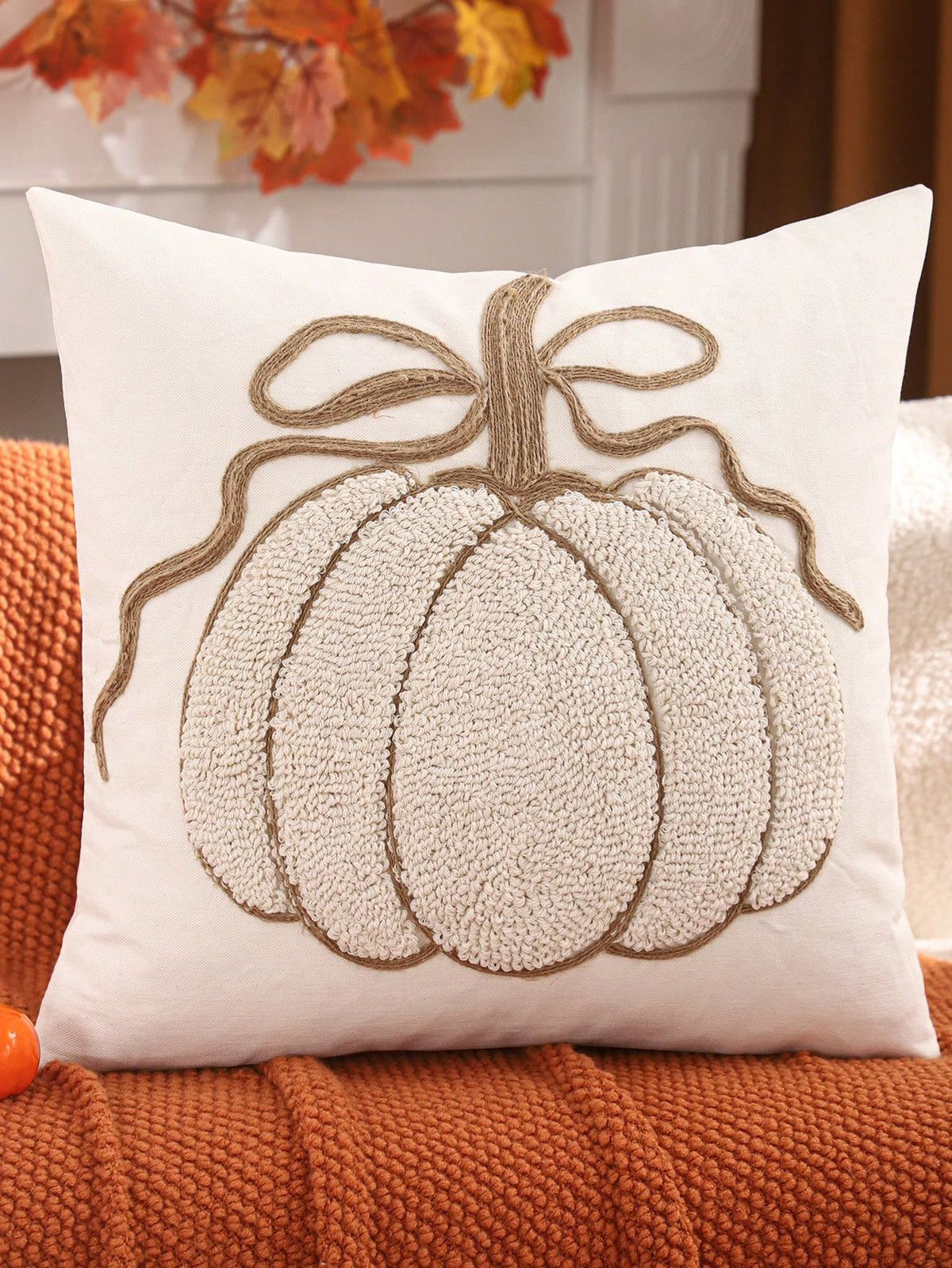 Chenille pumpkin pillow cover in cream/white with jute bow on rust orange throw