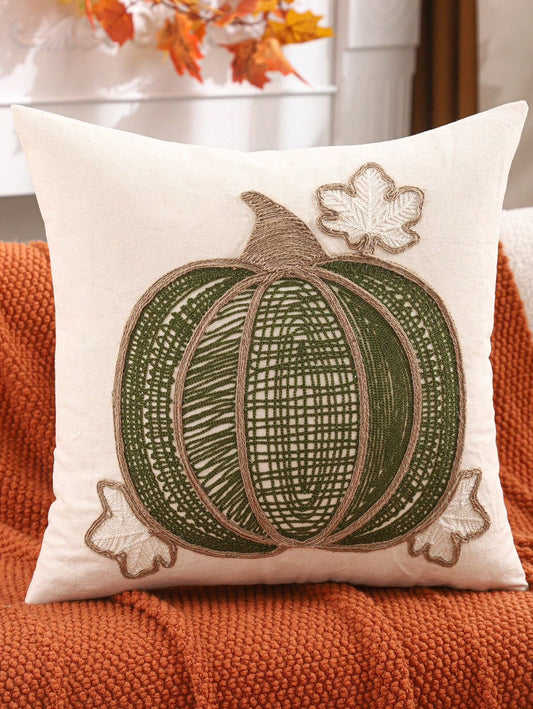 Lace embroidered pumpkin pillow cover in olive green with jute rope ribs and maple leaf accents on rust sofa
