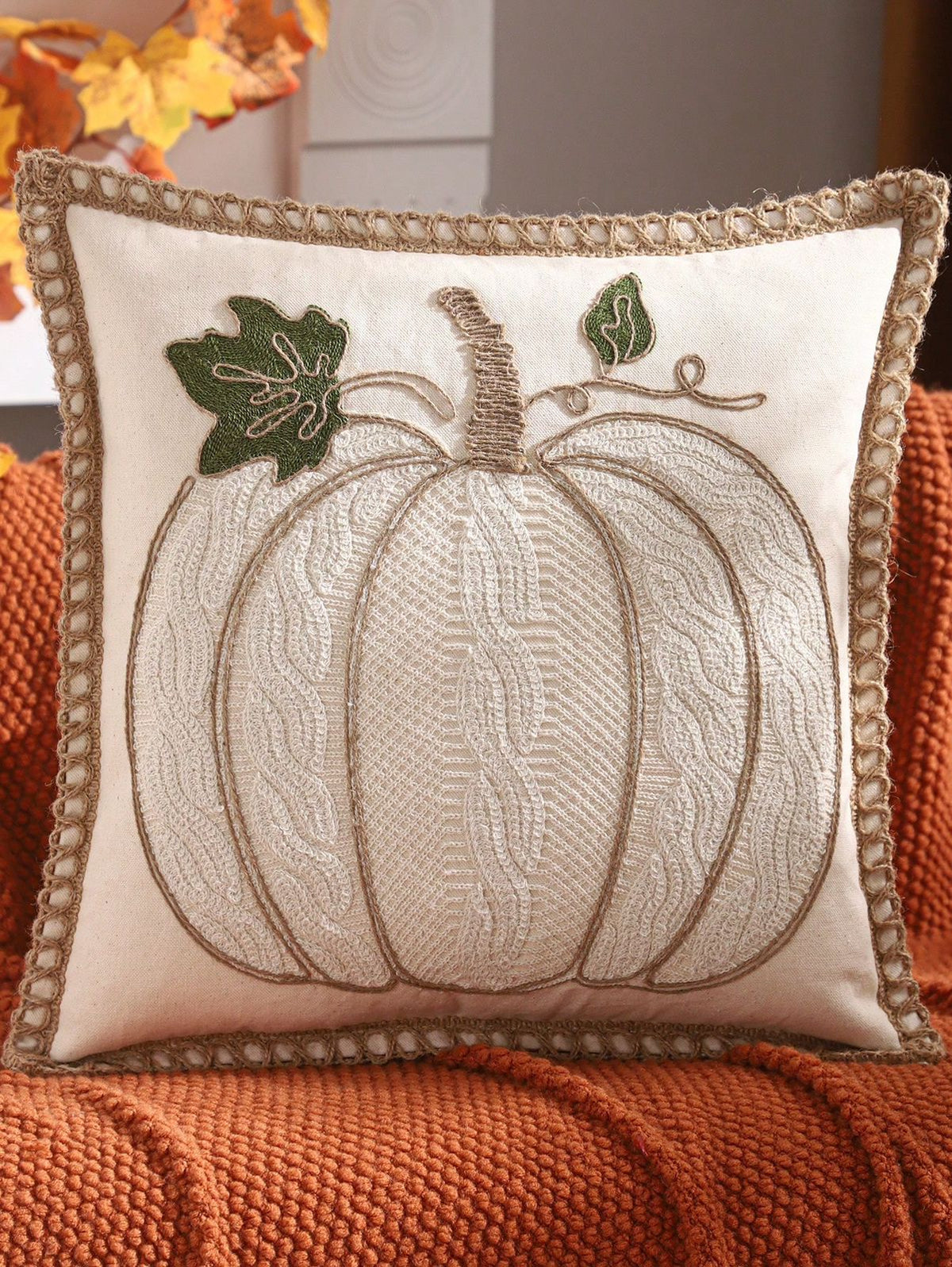 Design B: Large cream embroidered pumpkin with jute rope border trim and green leaf accents on cream pillow cover