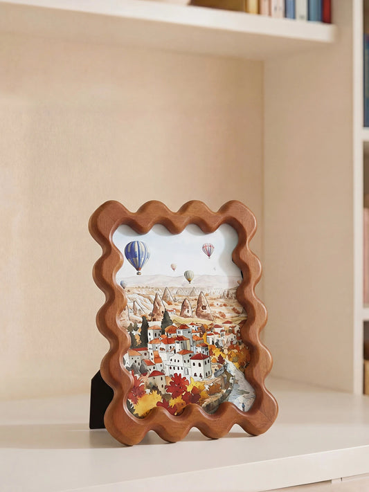 Wavy scallop-edge decorative photo frame in warm brown on white background showing full frame front