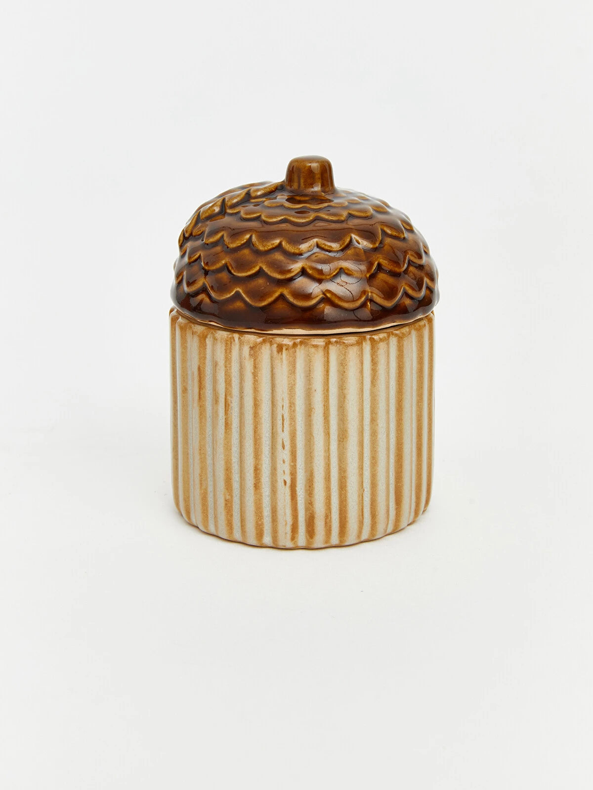 Ceramic acorn sugar bowl open showing ribbed cream base and dark brown sculpted acorn cap lid on white background