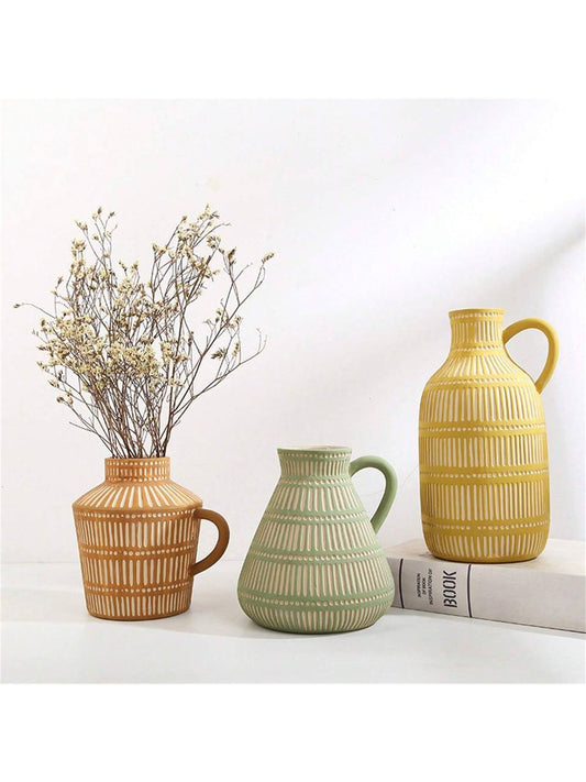 Three ceramic vases in different colors, warm tones for shelf and table decoration 