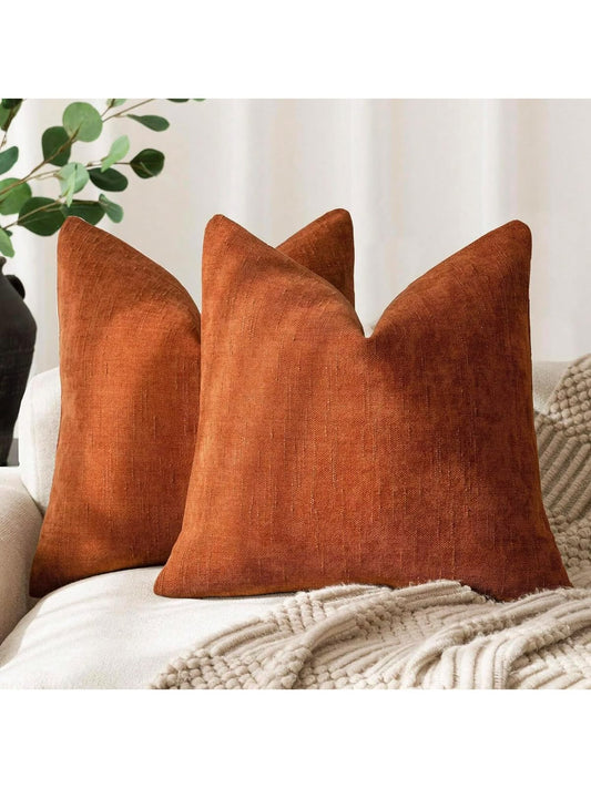 Rust orange textured linen look throw pillow cover on cream sofa