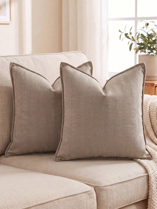 Taupe herringbone textured throw pillow covers styled on a neutral sofa